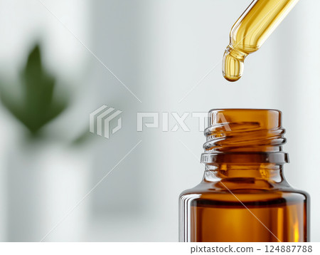 A luxurious glass serum bottle with a sleek dropper, a single drop of golden essential oil falling into the bottle A luxurious glass serum bottle with a sleek dropper, a single drop of golden essential oil falling into the bottle 124887788