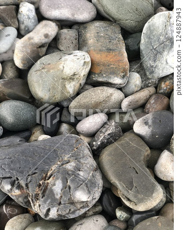 Beach pebble vertical shot for wallpaper, cover, banner, texture. Beautiful pebbles close-up. Natural sea stone background. Beach pebble vertical shot for wallpaper, cover, banner, texture. Beautiful pebbles close-up. Natural sea stone background. 124887943