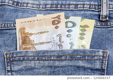 Yemeni Rial in the pocket of blue jeans Yemeni Rial in the pocket of blue jeans 124888337