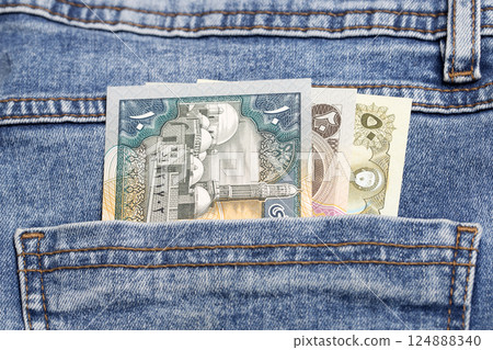 Old Yemeni Rial in the pocket of blue jeans Old Yemeni Rial in the pocket of blue jeans 124888340