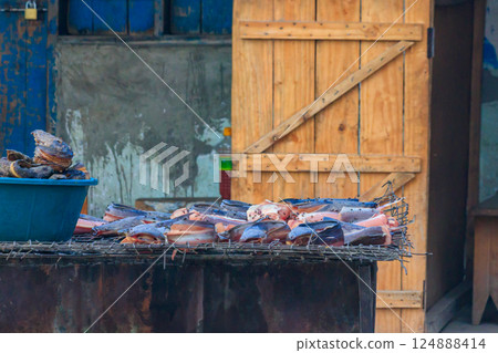 Fish cooking for sale at a local street food market in Tanzania 124888414