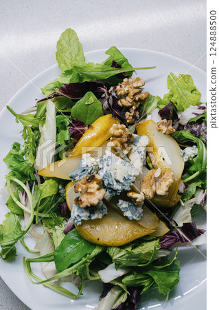 Enjoy an incredibly delicious and refreshing salad featuring pears, blue cheese, and walnuts Enjoy an incredibly delicious and refreshing salad featuring pears, blue cheese, and walnuts 124888500