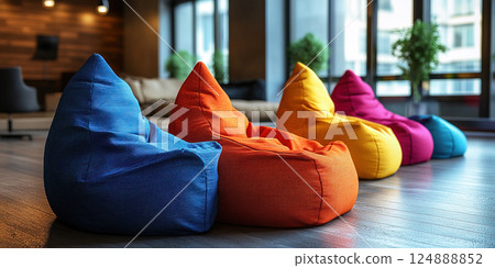 Colorful bean bag chairs arranged in a modern interior space for relaxation and comfort. Header banner mockup with copy space. 124888852