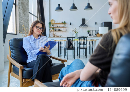Female social worker working at home with young woman 124889699