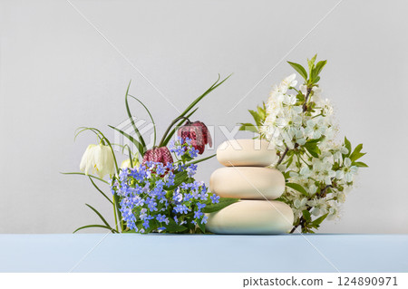 Wood slice podium with spring flowers grouse, blue brunnera sibirica, branches of cherry blossoms.. Concept scene stage showcase for new product, banner, promotion sale, cosmetic, presentation Wood slice podium with spring flowers grouse, blue brunnera sibirica, branches of cherry blossoms.. Concept scene stage showcase for new product, banner, promotion sale, cosmetic, presentation 124890971