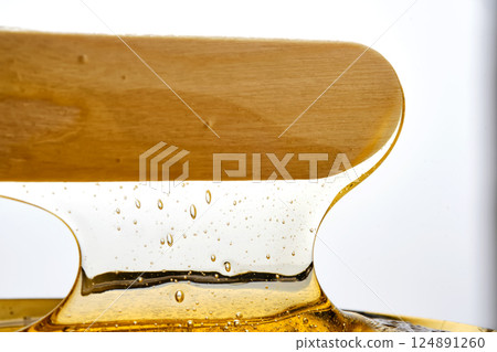 Photo of a sugar paste for depilation hair removal procedure. Texture. 124891260