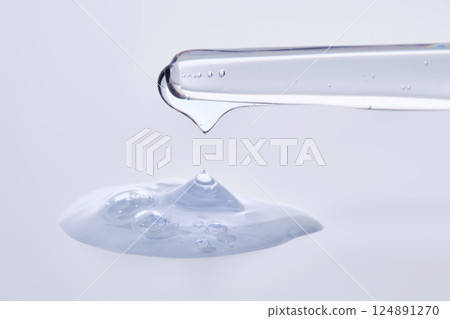 Pipette with delicate blue serum close-up. 124891270