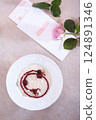 Homemade rice porridge for breakfast. Porridge with blackberries. View from above. Healthy eating. Top view. Pink roses on the table. 124891346