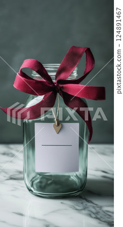 Glass jar with a red ribbon and blank tag on marble surface, copy space, background Glass jar with a red ribbon and blank tag on marble surface, copy space, background 124891467