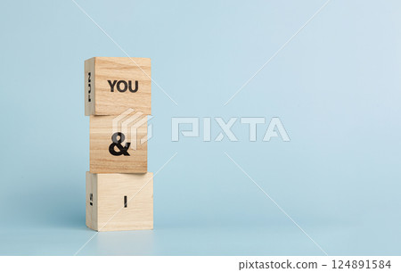 Wooden cubes with inscriptions You And I on a blue background 124891584