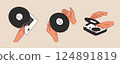 Hands holding a vinyl record. Portable turntable with vinyl playing. Old gramophone with analog grooved LP disc. 124891819