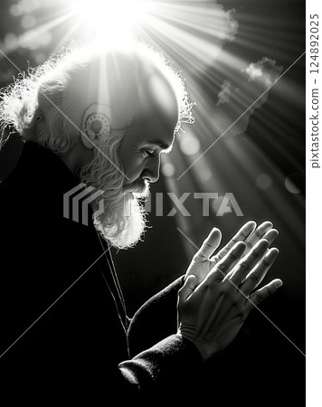A man with a long white beard and a white beard is praying 124892025