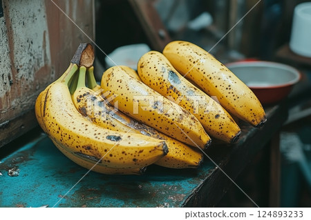 Ripe yellow bananas on a wooden table in a market setting 124893233