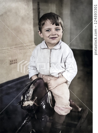 Vintage portrait of a little boy riding a wooden horse. Retro photo from 1938. 124893301