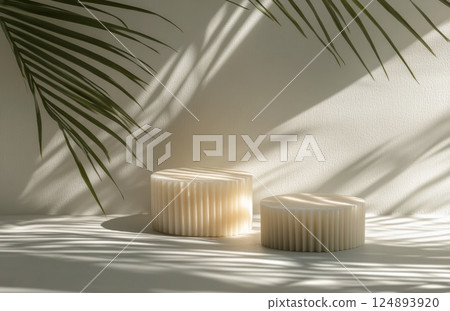 Stylish decorative objects cast shadows against a light wall with palm leaves in the background 124893920