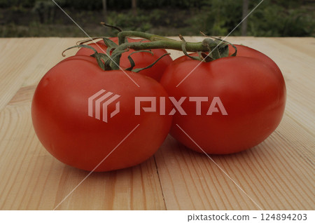 Whole Juicy Tomato Fruits On A Wooden Planks Table Closeup Side View  124894203