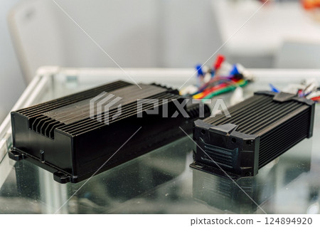 Electric motorcycle charging power supply. Portable charger for charging batteries in a scooter Electric motorcycle charging power supply. Portable charger for charging batteries in a scooter 124894920