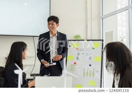 ESG Data Analysis and Team Engagement. Professionals analyzing sustainable growth metrics in an interactive meeting. ESG Data Analysis and Team Engagement. Professionals analyzing sustainable growth metrics in an interactive meeting. 124895158