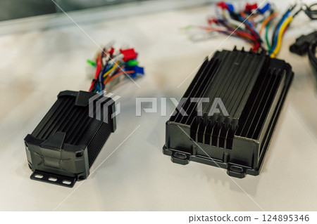 Electric motorcycle charging power supply. Portable charger for charging batteries in a scooter 124895346