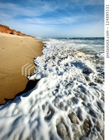 Waves on the sand at Falesia beach, Algarve, Portugal  124895531