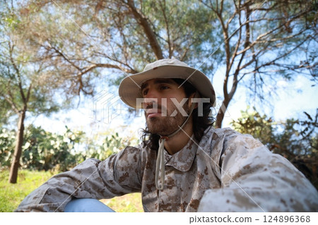 Sad Serviceman Sitting On The Ground In The Countryside Reflects On Memorial Day Sad Serviceman Sitting On The Ground In The Countryside Reflects On Memorial Day 124896368