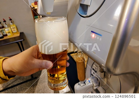 Image of pouring draft beer from a beer server Image of pouring draft beer from a beer server 124896501