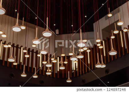eco lamps in the exhibition hall. round lamps on the background of perforated aluminum 124897246