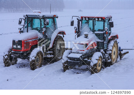 The tow truck left in the field is covered in snow The tow truck left in the field is covered in snow 124897890