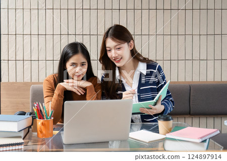 Educational Interaction and Study Goals. Two friends engaged in a focused study session for their academic objectives. 124897914
