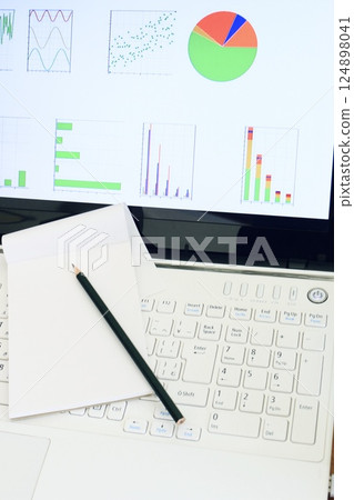 Business image, graph and computer, chart, desk work, vertical position Business image, graph and computer, chart, desk work, vertical position 124898041