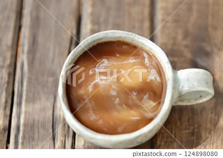 Cafe au lait with milk just added but not fully mixed 124898080