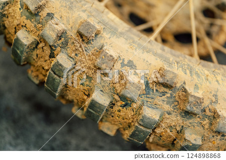 dirty off-road enduro motorcycle. dirt bike tire from cross country racing 124898868