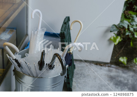 Umbrellas, umbrella stand, store 124898875