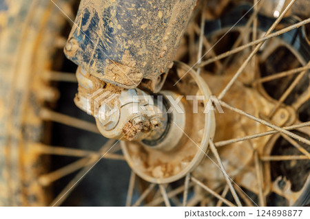 dirty off-road enduro motorcycle wheel. dirt motorcycle tire from off-road racing dirty off-road enduro motorcycle wheel. dirt motorcycle tire from off-road racing 124898877