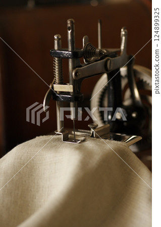 Antique hand-cranked sewing machine 124899325