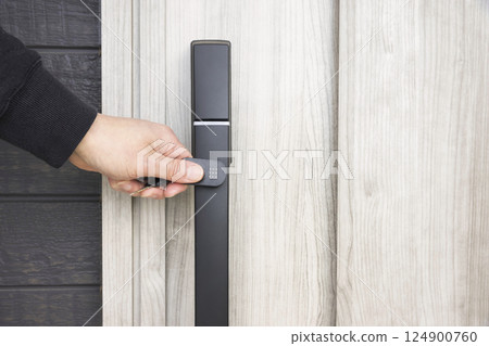 Image of unlocking the front door with a touch key Image of unlocking the front door with a touch key 124900760