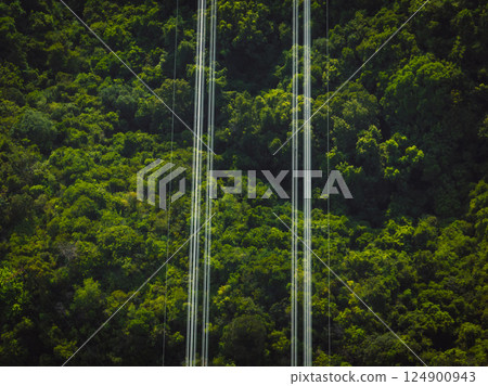 Aerial view of high voltage electric lines in forest Aerial view of high voltage electric lines in forest 124900943