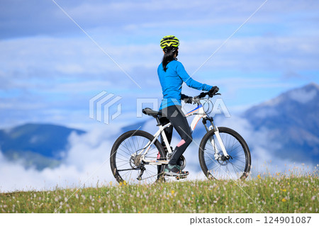 Riding mountain bike on beautiful mountain top Riding mountain bike on beautiful mountain top 124901087