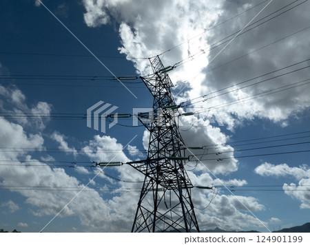Aerial view of high voltage electric tower in city 124901199