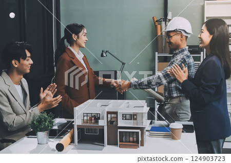 Construction, planning and architects meeting about design of building, strategy and working in industrial collaboration. Architecture workers talking about maintenance project with paper and a model Construction, planning and architects meeting about design of building, strategy and working in industrial collaboration. Architecture workers talking about maintenance project with paper and a model 124903723