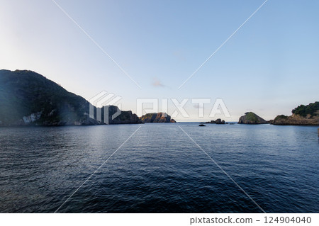 The calm Nakagi Port where fishing boats are moored. Columnar joints can be seen on the adjacent rocky mountain. Hirizohama Nakagi Minamiizu Town Izu Peninsula Shizuoka Prefecture 124904040