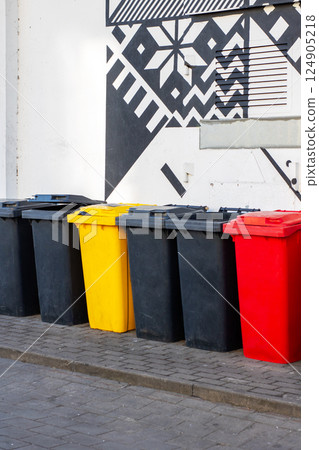 Vibrant and Colorful Waste Bins Set Against a Creative and EyeCatching Modern Mural 124905218