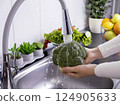 Woman hands washing fresh broccoli in the kitchen 124905633