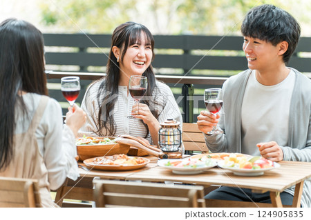 Group of young Asian men and women having a home party glamping on a wooden deck Group of young Asian men and women having a home party glamping on a wooden deck 124905835