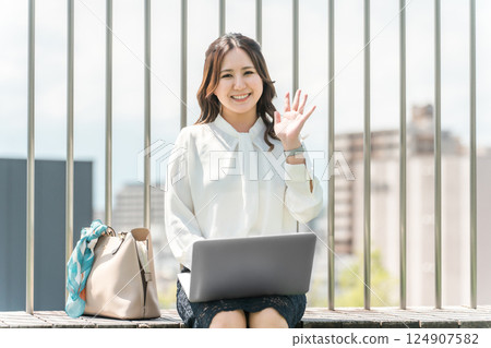 Asian business woman in a suit using a laptop on the rooftop 124907582