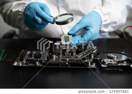 Hands repairing electronic devices. Electronic technician. 124907881