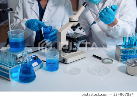Scientist in laboratory study and analyze scientific sample. Scientist in laboratory study and analyze scientific sample. 124907884