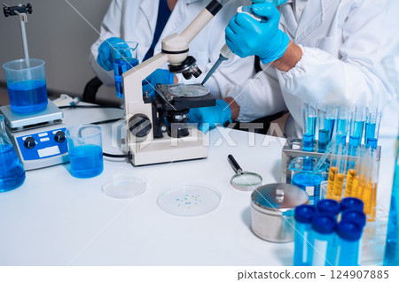Scientist in laboratory study and analyze scientific sample. Scientist in laboratory study and analyze scientific sample. 124907885