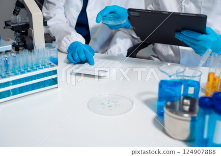 Scientist in laboratory study and analyze scientific sample. Scientist in laboratory study and analyze scientific sample. 124907888