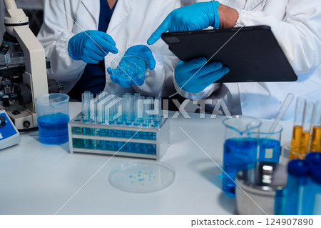 Scientist in laboratory study and analyze scientific sample. Scientist in laboratory study and analyze scientific sample. 124907890